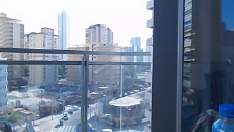 Attractive Gamer Woman Wearing Clothes Reveals Herself On A High-Rise Balcony